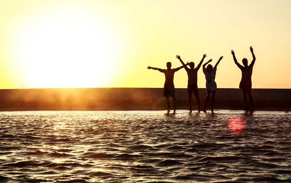 silhouette of people enjoying fun on the beach.